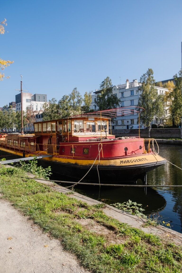 Red and yellow barge docked on a canal