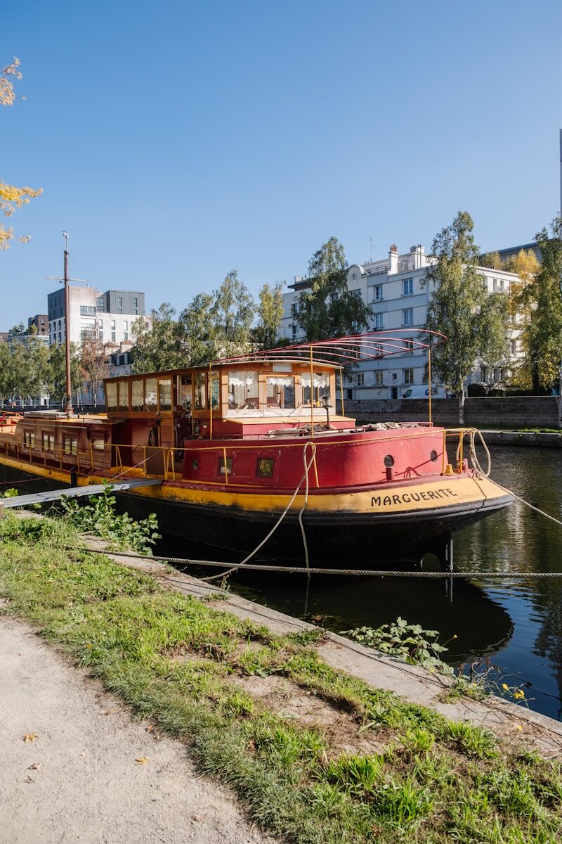 Red and yellow barge docked on a canal