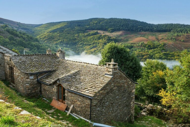 Stone houses nestled in a lush green valley
